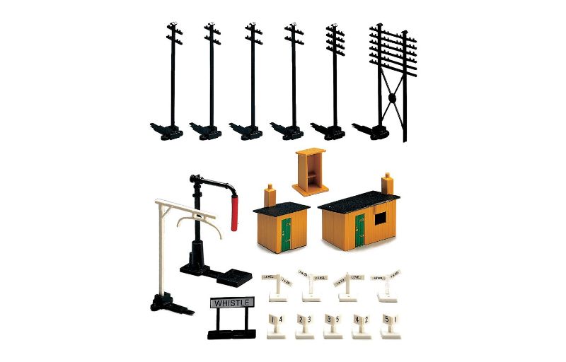 Hornby Trackside Access Pack featuring huts, telegraph poles, water crane, and signs for realistic model railway setups.