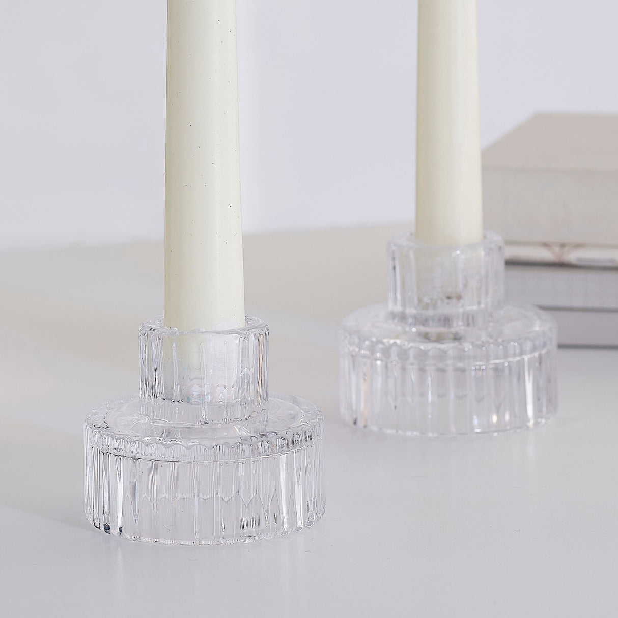 Elegant ribbed glass candle holders for festive decor, evoking winter wonderland warmth with a modern touch.