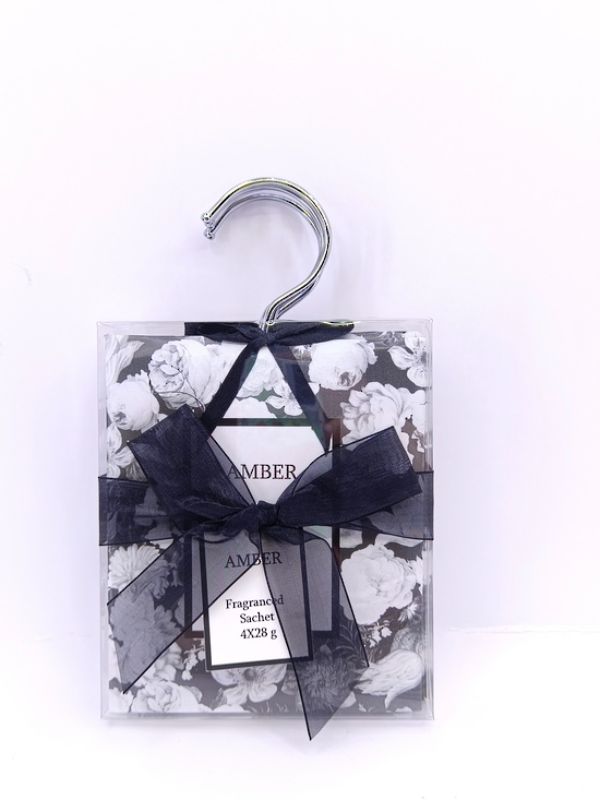 Pack of 4 amber scented sachets for closets and drawers, creating a warm and inviting fragrance in any space.