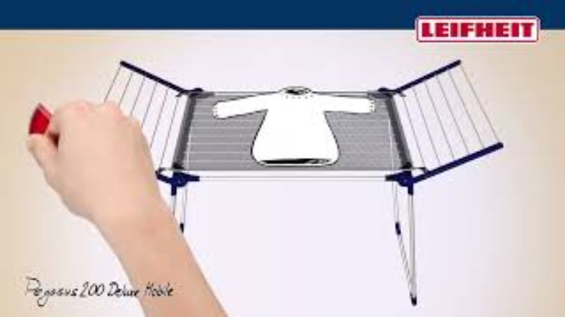 Leifheit Pegasus 200 Solid Deluxe clothes dryer with 20m drying line, dual wheels, and holders for small items.