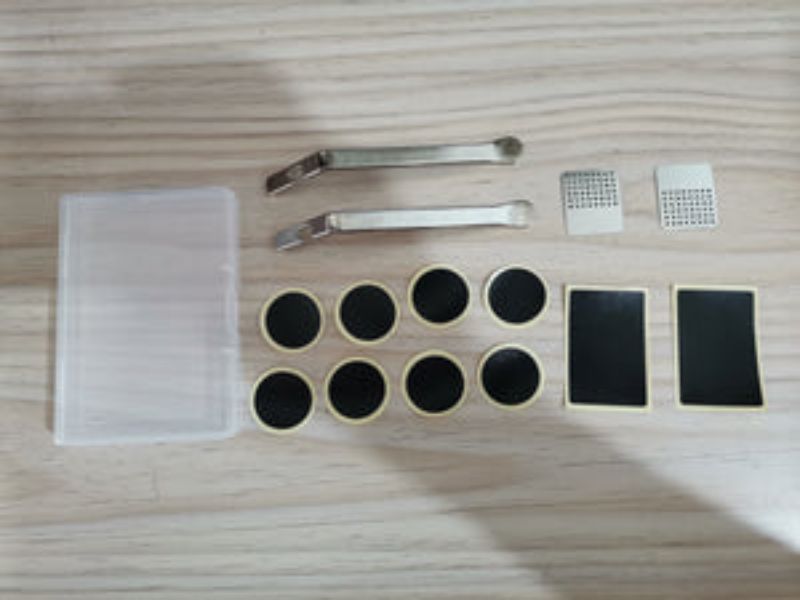 BICYCLE TUBE REPAIR KIT XCEL: compact repair kit with patches, adhesive, and lever for quick flat tire fixes.