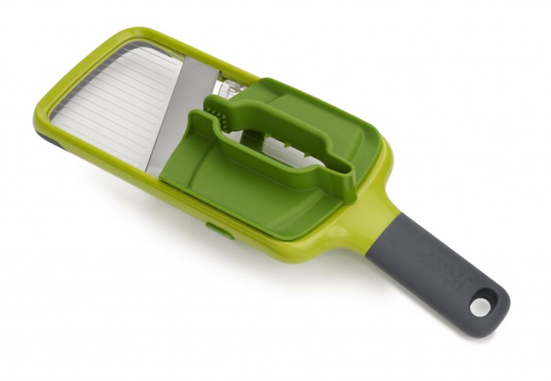 Joseph Joseph Multi-Grip Mandoline in green, featuring adjustable thickness and three grip styles for easy vegetable slicing.
