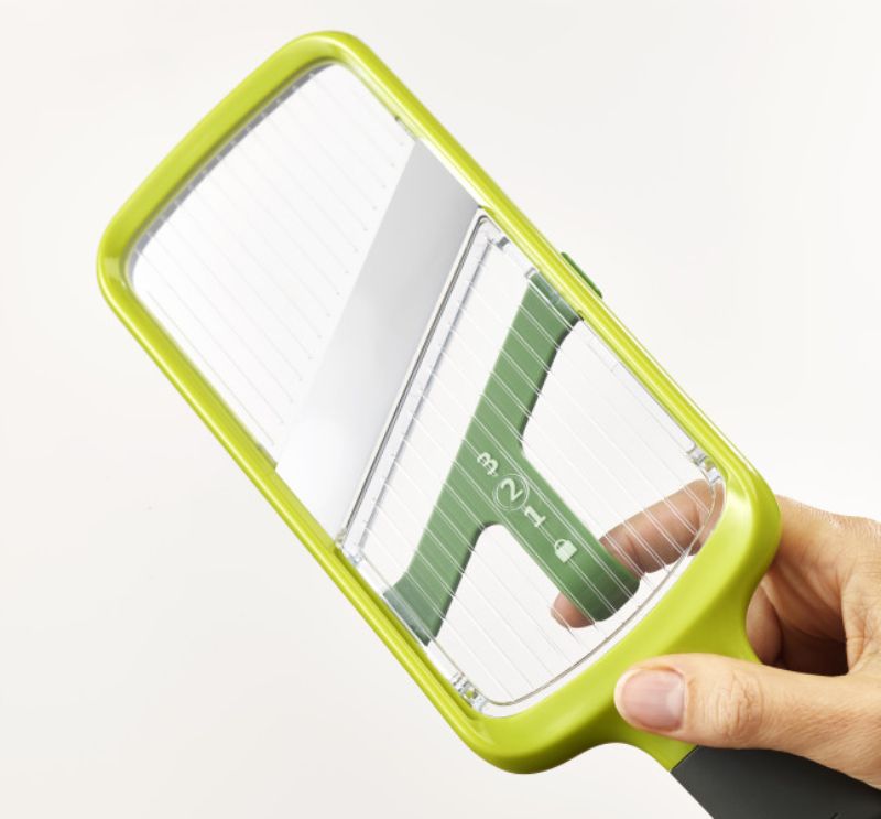 Joseph Joseph Multi-Grip Mandoline in green, featuring adjustable slice thickness and versatile grip styles for effortless slicing.