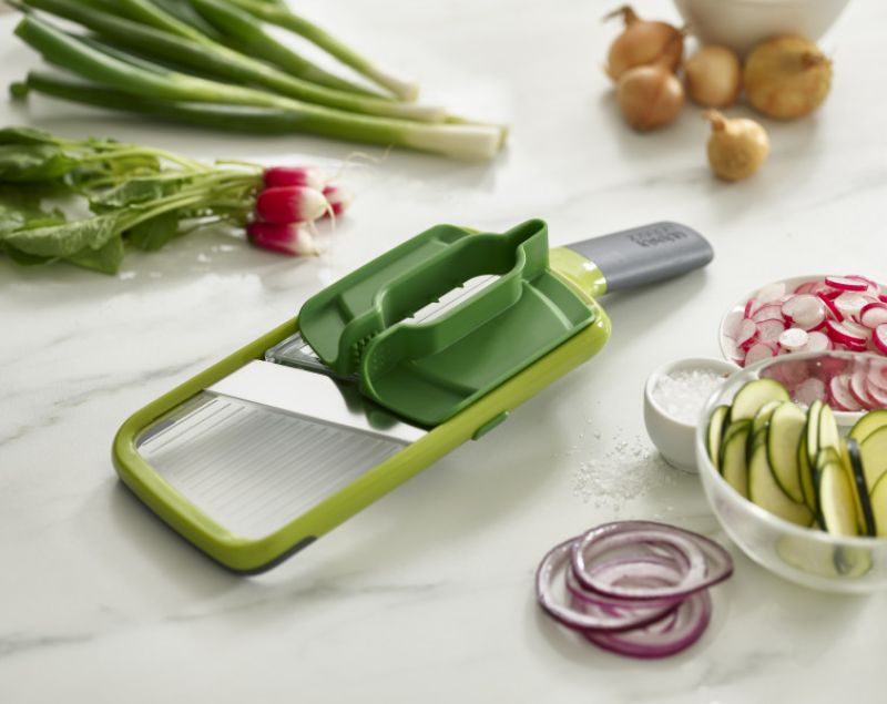 Joseph Joseph Multi-Grip Mandoline in green, featuring versatile grips and adjustable slice thickness for precise vegetable prep.