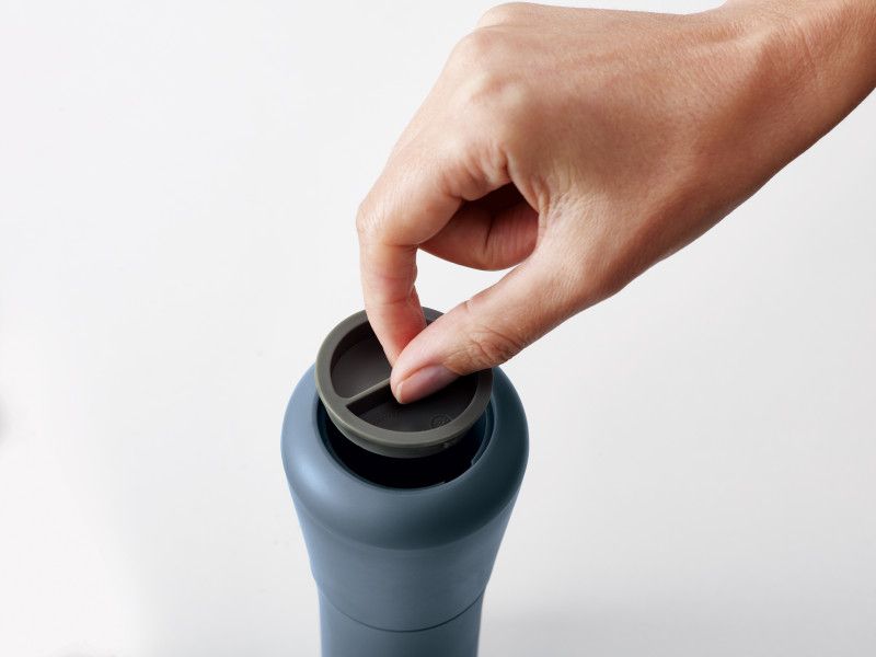 Joseph Joseph Milltop Salt & Pepper Set in sky-blue with inverted design for mess-free seasoning and adjustable grind size.