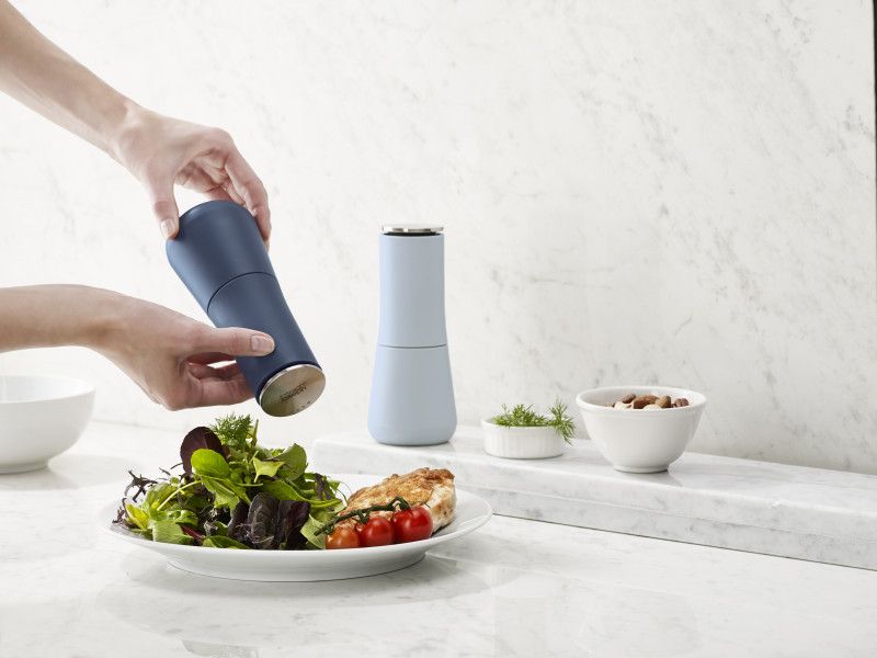 Joseph Joseph Milltop Salt & Pepper Set in sky blue, featuring an inverted design for mess-free seasoning and adjustable grind sizes.