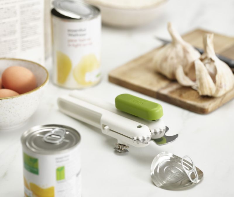 Joseph Joseph Pivot 3-in-1 Can Opener in white and green, combines can opener, bottle opener, and ring-pull lifter.