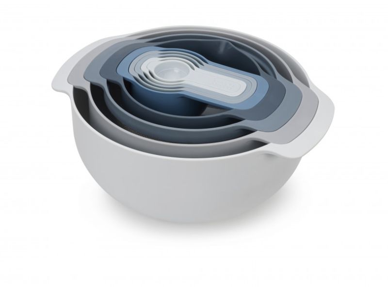 Joseph Joseph Nest 9 Plus food prep set in sky blue with nesting design, mixing bowls, colander, sieve, and measuring cups.
