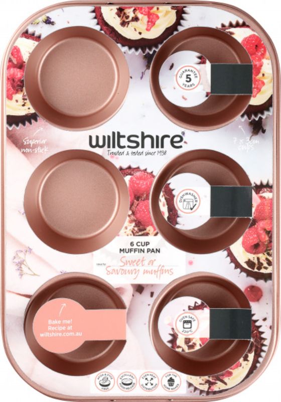 Stylish rose gold 6-cup muffin pan with non-stick coating and embossed measurements for perfect baking results.