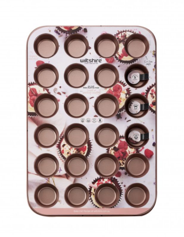 Wiltshire 24 Cup Muffin Pan in rose gold, featuring non-stick coating and removable base for easy baking and cleaning.