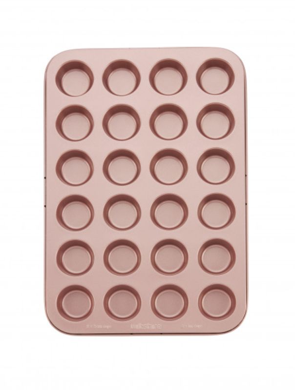 Wiltshire 24-cup muffin pan in rose gold, featuring non-stick coating, removable base, and embossed measurements for easy baking.