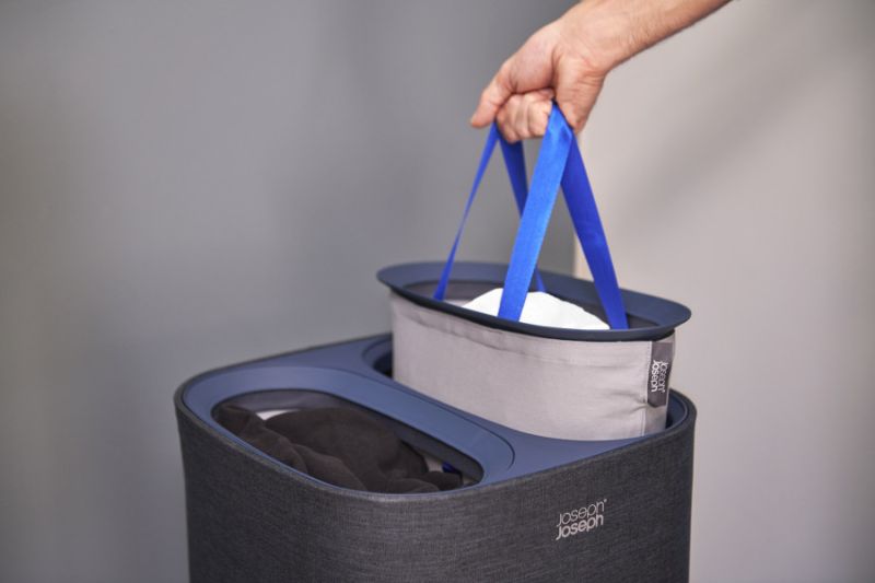 Joseph Joseph Tota 60-litre laundry basket in carbon black with dual compartments for separating light and dark clothing.
