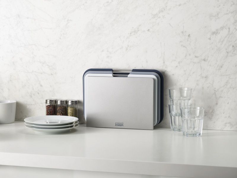 Joseph Joseph Nest Boards set with three color-coded chopping boards, stylish grey stand, and non-slip features for safe food prep.