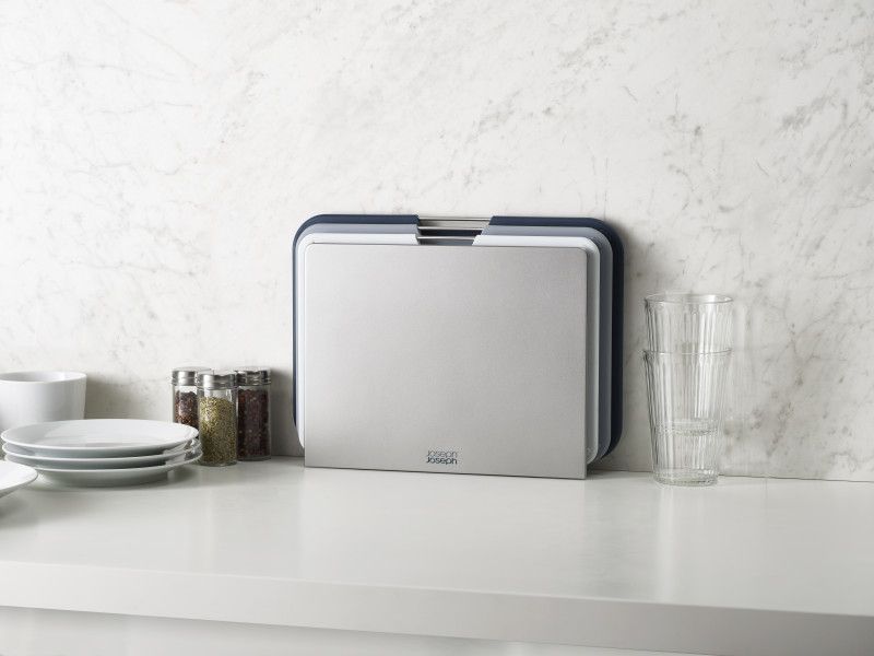 Joseph Joseph Nest Boards Large 3 Piece Set in Grey featuring three color-coded chopping boards with stainless-steel lift bars.