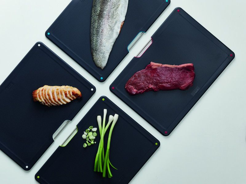 Joseph Joseph Folio Steel 4-piece chopping board set with colorful boards in a stylish stainless steel case, ideal for modern kitchens.