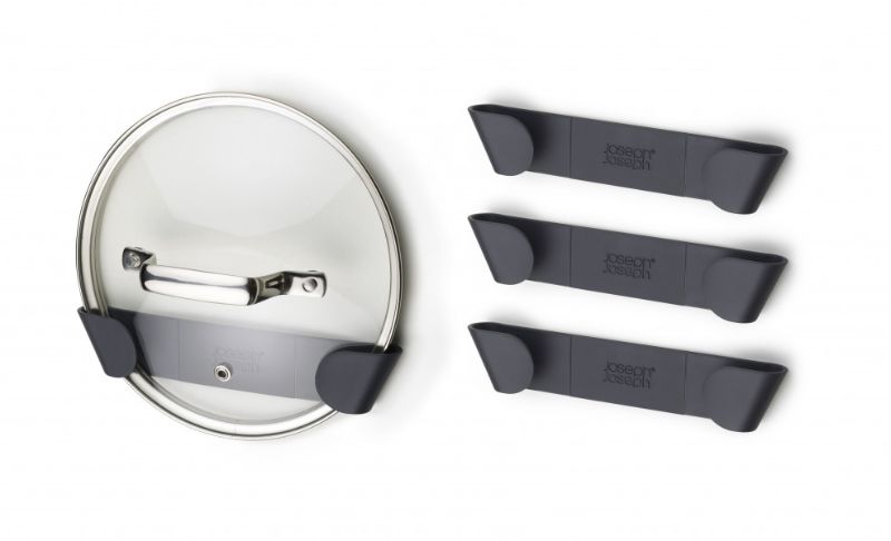 Set of 4 Joseph Joseph pan lid holders for organized kitchen storage, fitting lids 16-24 cm with easy peel-and-stick installation.