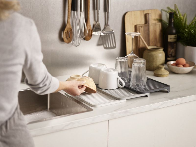 Joseph Joseph Tiered Dish Drainer: expandable, space-saving design for efficient dish drying and easy storage.