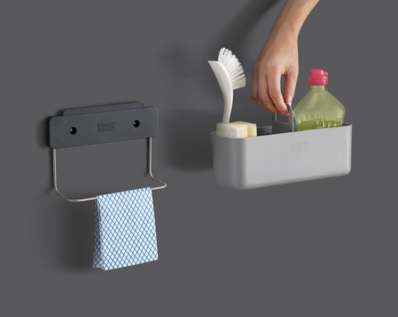 Joseph Joseph DoorStore Sink Tidy in Grey, designed for cupboard organization of cleaning essentials, with a carry handle and stainless-steel rail.