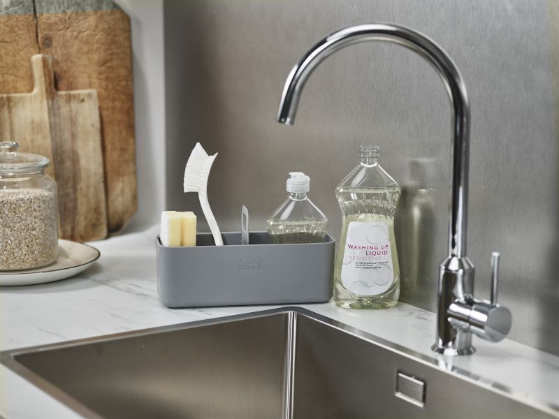Joseph Joseph DoorStore Sink Tidy in Grey for organized cleaning supplies, with carry handle and stainless-steel rail.