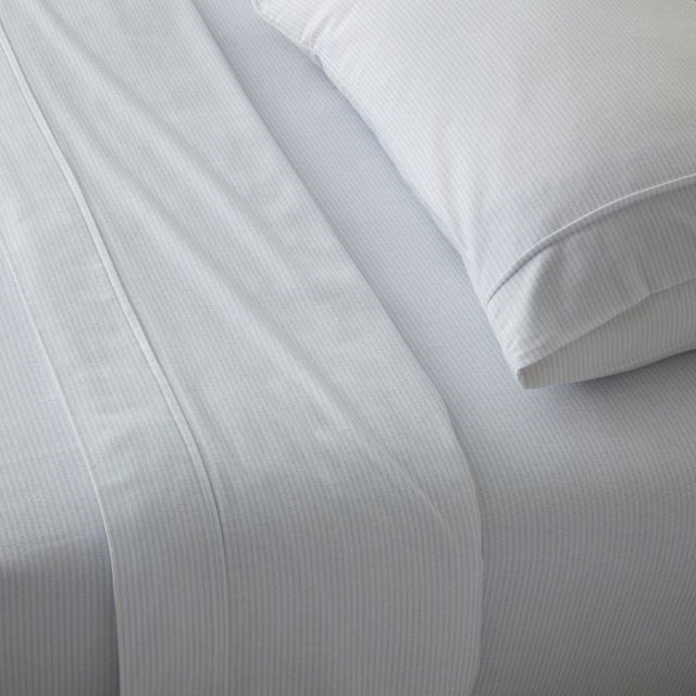 Luxurious OXFORD Blue Stripe Flannel Sheet Set from BAKSANA, crafted from 100% brushed cotton for ultimate comfort.