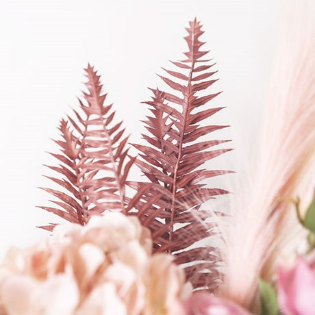 Dusty pink artificial fern spray, 54cm tall, adds whimsical elegance and charm to home decor and floral arrangements.