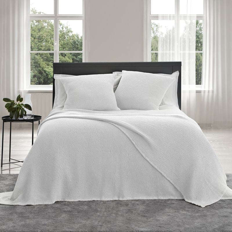 Large white stonewashed blanket with deep waffle texture, made from 100% OEKO-TEX® cotton, ideal for cozying up.