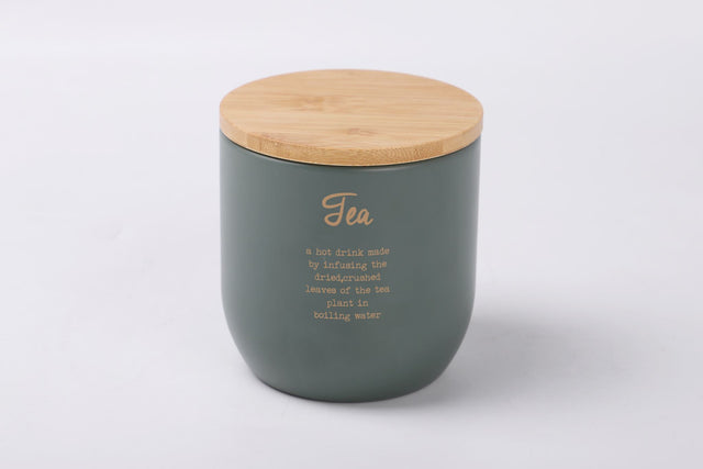 Rockingham Tea Tin: Stylish gray-green metal storage with gold lettering, bamboo lid, and rubber seal for freshness.