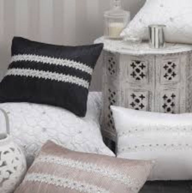 Elegant Aimee Shell Brunch Cushion features pleated design, lace trim, and diamante buttons for stylish home decor.