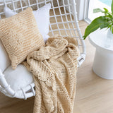 Hand-crocheted cotton throw in custard featuring a floral motif, perfect for cozy decor and layering.