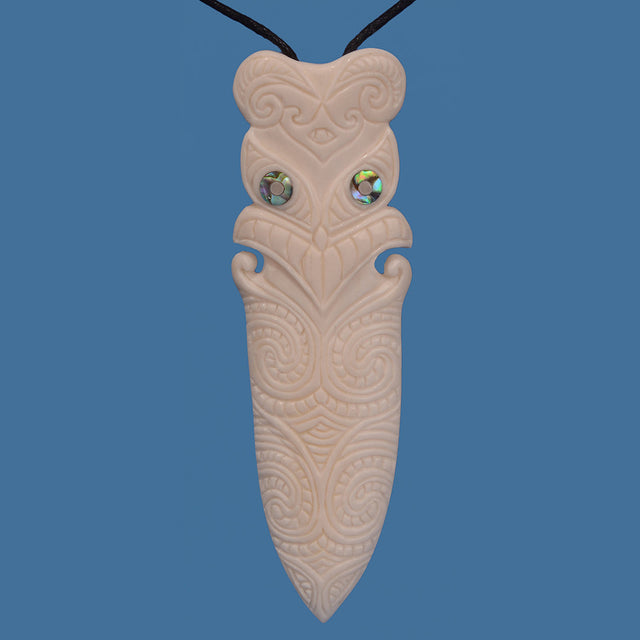 Intricately carved Bone Tiki Taiaha Head Pendant on an adjustable black cord, symbolizing M?ori heritage and strength.