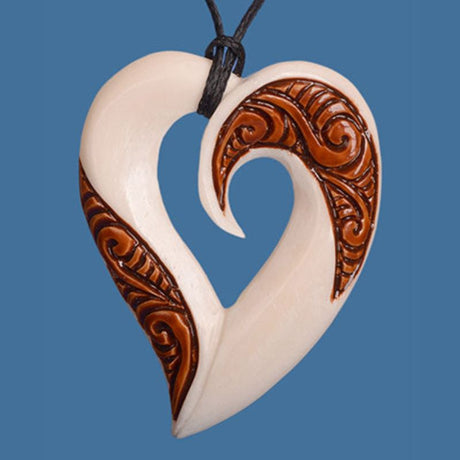 Bone Stained Heart Pendant, handcrafted Maori jewelry symbolizing love and connection, on adjustable black wax cord.