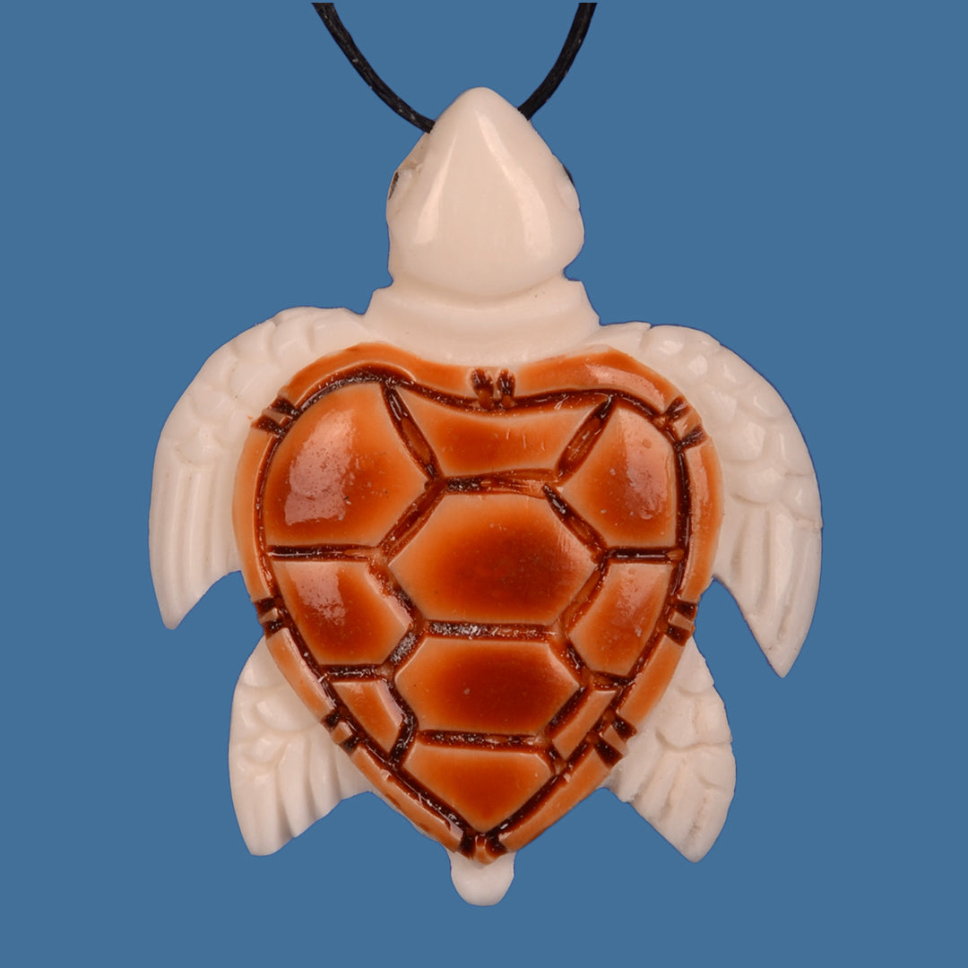 Handcrafted bone turtle pendant with intricate carvings, adjustable cord, celebrating ocean beauty and wildlife artistry.