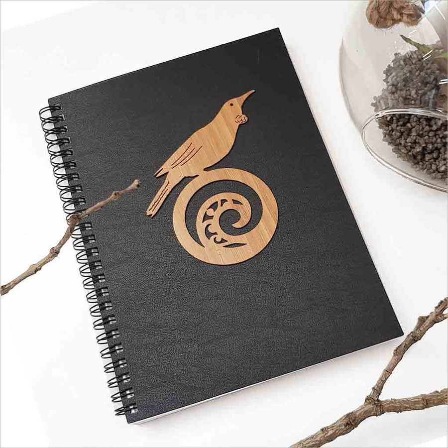 Kiwiana Black Journal featuring Tui bird on Koru design, perfect for writing and creativity with 120 acid-free pages.