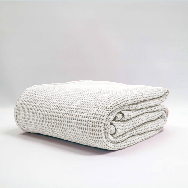 Large stonewashed silver blanket by Baksana with a textured waffle weave, perfect for adding comfort to any space.