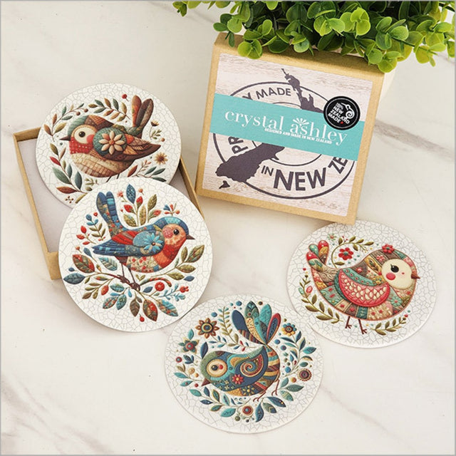 Colorful patchwork bird coasters made from durable acrylic with cork base, perfect for home decor and drink protection.