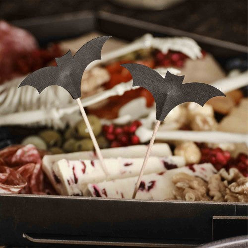 Set of 12 black bat cocktail sticks, 10cm tall, perfect for Halloween parties and themed drinks.