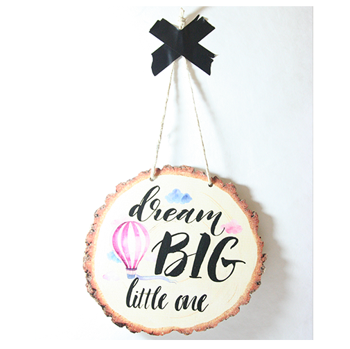 Rustic wood slice wall art with 'Dream Big' message, made from eco-friendly pine veneer, ideal for inspiring decor.