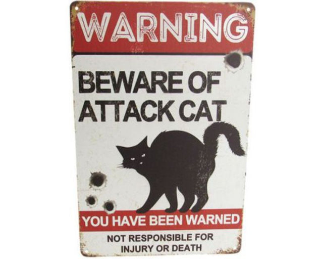 Retro attack cat tin sign with playful graphic, perfect for cat lovers and quirky home decor. Measures 30cm x 20cm.