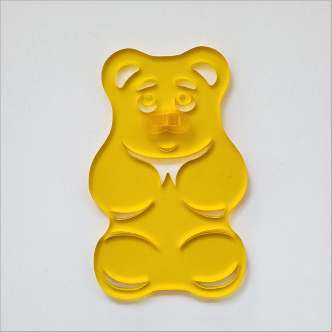 Yellow satin acrylic gummy bear art piece, whimsical decor for children's rooms and playful spaces.
