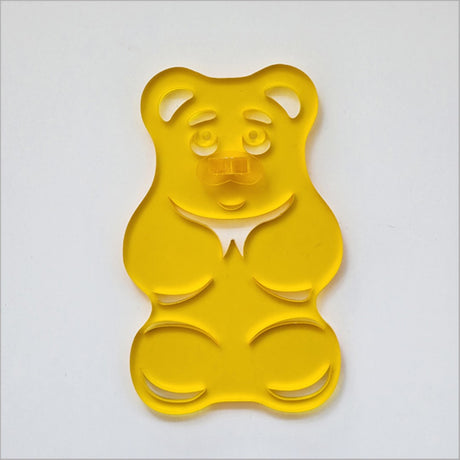 Yellow satin acrylic gummy bear art piece, whimsical decor for children's rooms and playful spaces.