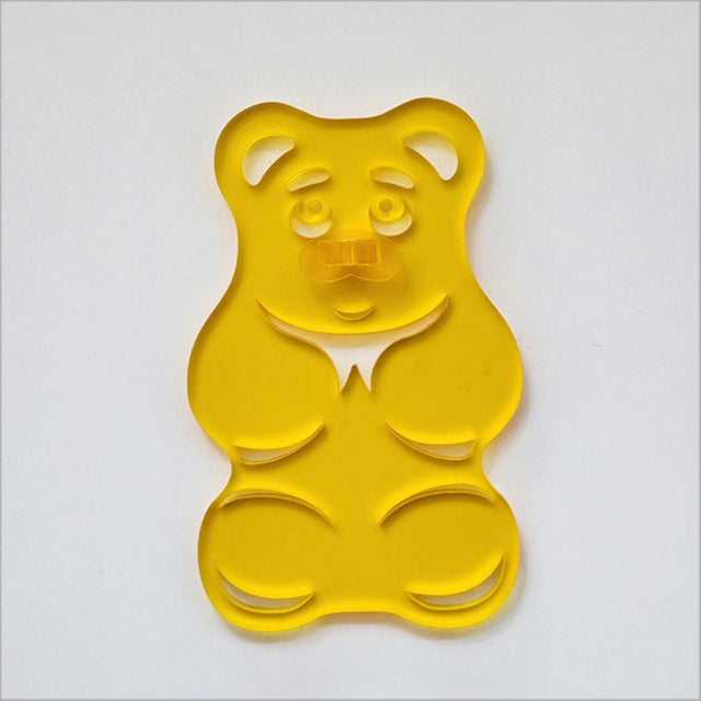 Yellow satin acrylic gummy bear art piece, whimsical decor for children's rooms and playful spaces.