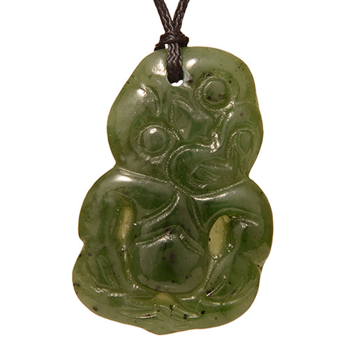 Jade Tiki Pendant, 42mm, carved jade symbolizing luck and fertility, presented on an adjustable black cord.