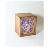 Eco-friendly bamboo tealight box with laser-cut Tui design and color-changing LED candle, doubles as a trinket holder.