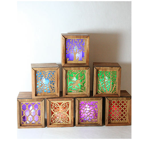 Eco-friendly bamboo tealight box featuring intricate designs and a color-changing LED candle, doubles as a trinket holder.