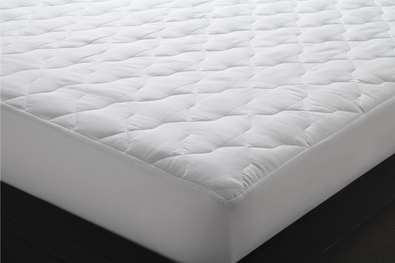 Quilted double mattress protector by Logan & Mason in white, featuring soft cotton cover and secure fit for enhanced comfort.