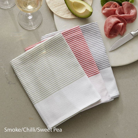 Set of three absorbent tea towels in Smoke, Chilli, and Sweet Pea colors, made from OEKO-TEX® Certified cotton.