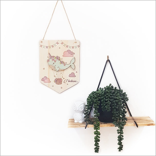 Whimsical narwhal wall art in eco-friendly pine, featuring 'I Believe', perfect for adding oceanic charm to any room.