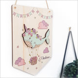 Whimsical narwhal wall art on eco-friendly pine veneer with 'I Believe' message, perfect for any child's room.