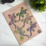 Colorful laser-cut gecko wall art set, expertly crafted, perfect for nature-inspired decor in any room.