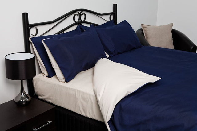 Blue and oyster reversible double duvet cover with matching pillowcases, crafted for luxury and comfort.
